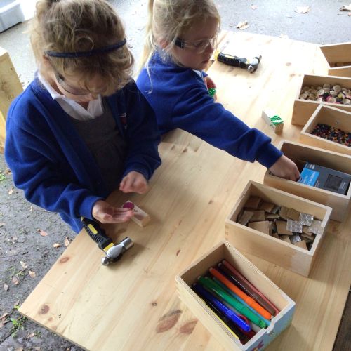 Robins enjoying using the wood working tools!